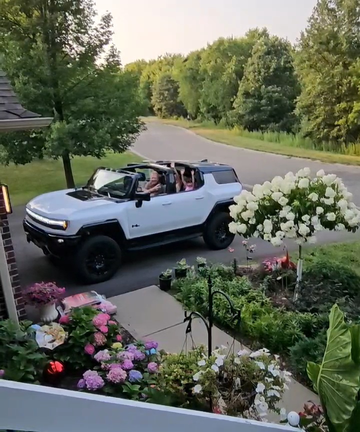 White HUMMER EV arriving during a summer evening