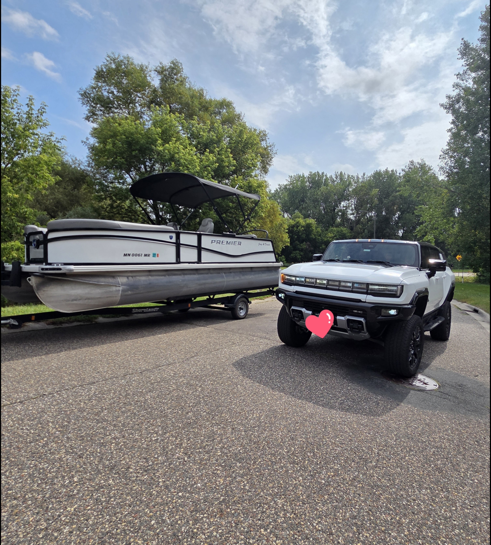 White Premier pontoon and white HUMMER EV together before a lake trip